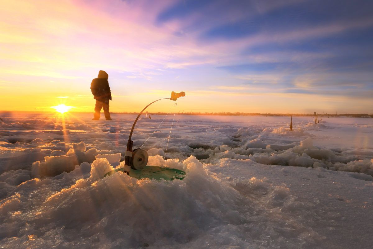ice-fishing-on-a-river-at-sunset