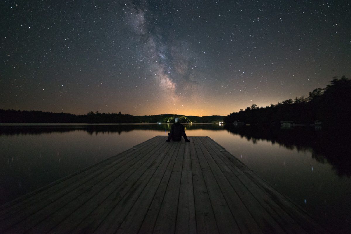 man-at-end-of-dock-stargazing-in-Muskoka