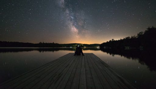 man-at-end-of-dock-stargazing-in-Muskoka