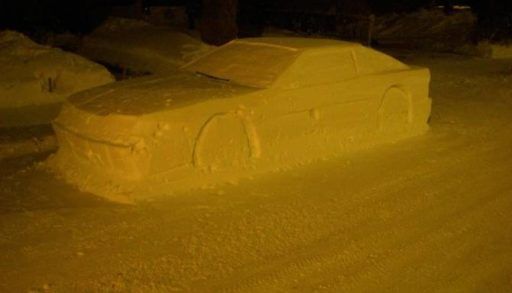 Realistic car sculpture made of snow on the city street