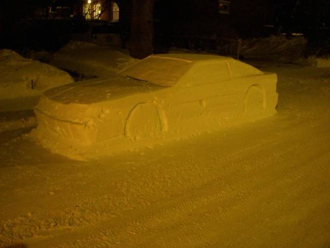 Realistic car sculpture made of snow on the city street
