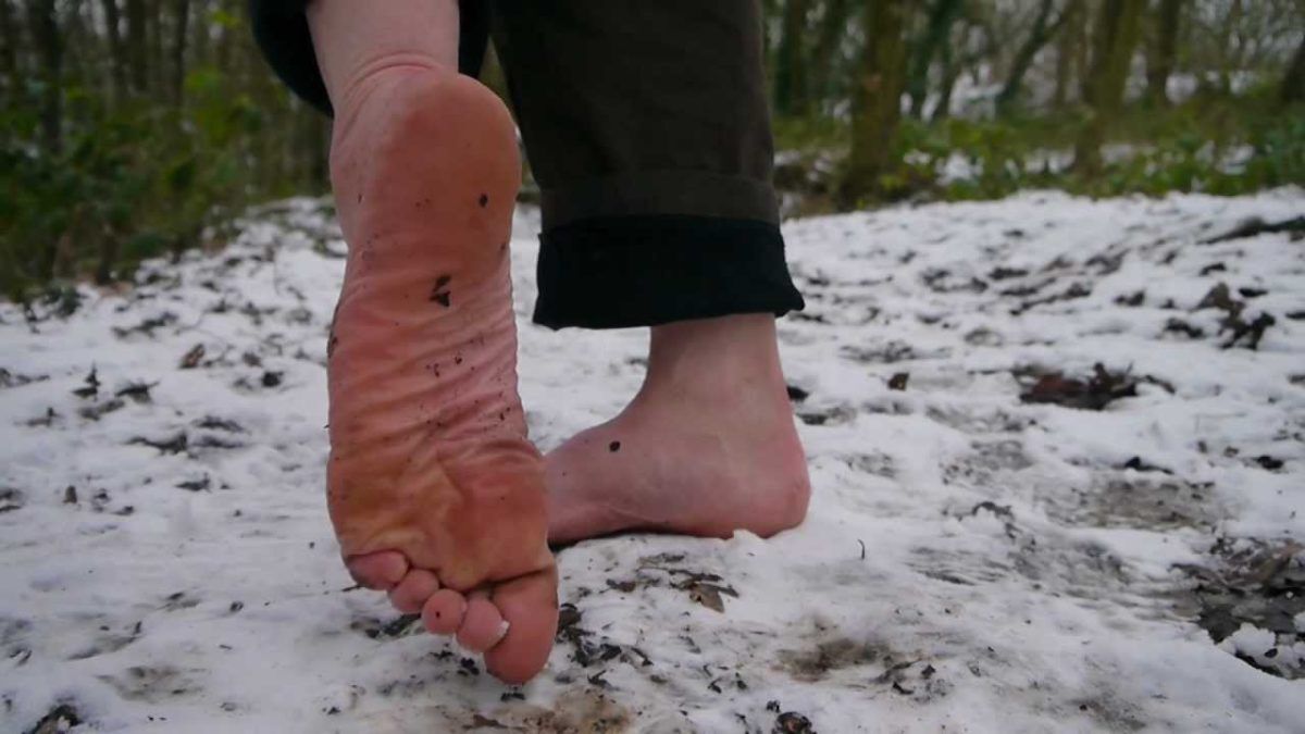 Closeup of bare feet on snow
