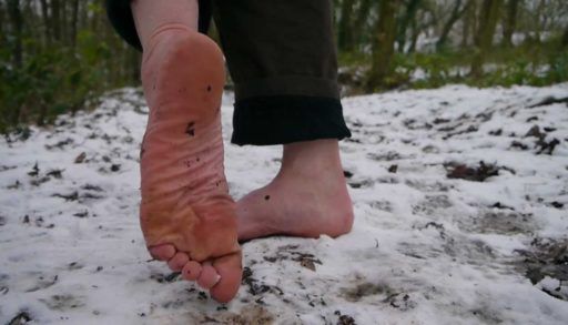 Closeup of bare feet on snow