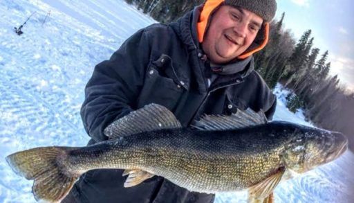 Robert Monty holds the giant walleye he caught