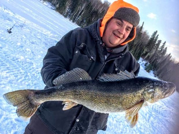 Robert Monty holds the giant walleye he caught