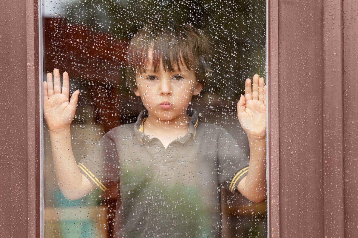 bored-kid-looking-out-rainy-window