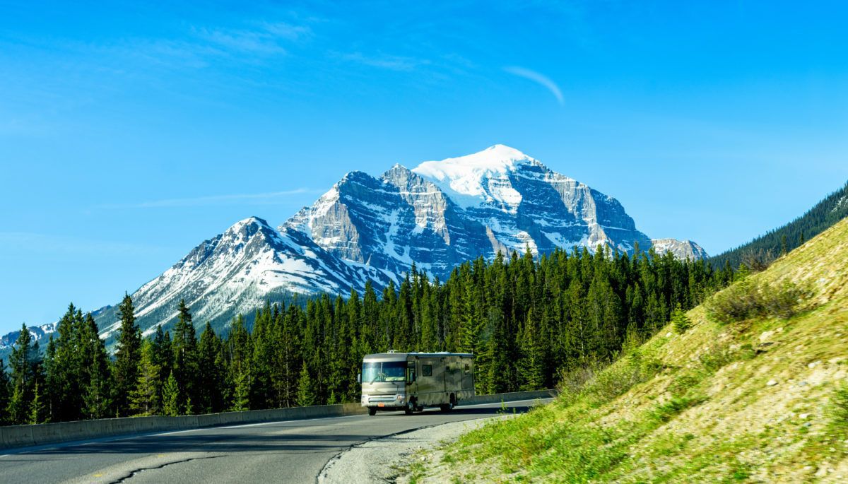 tour-bus-in-Canada-mountains-background