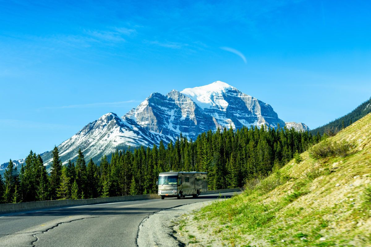 tour-bus-in-Canada-mountains-background