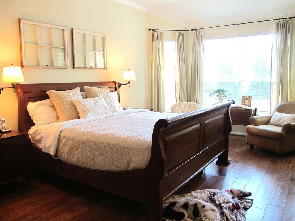 Picture of a neutral-coloured bedroom with big windows