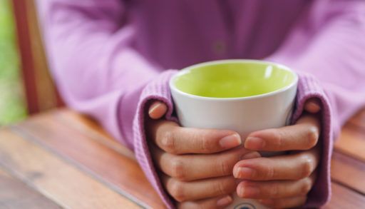 Hands holding a mug of tea