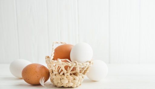 basket of eggs on white background