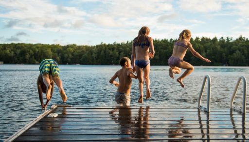 kids-jumping-off-dock-into-lake