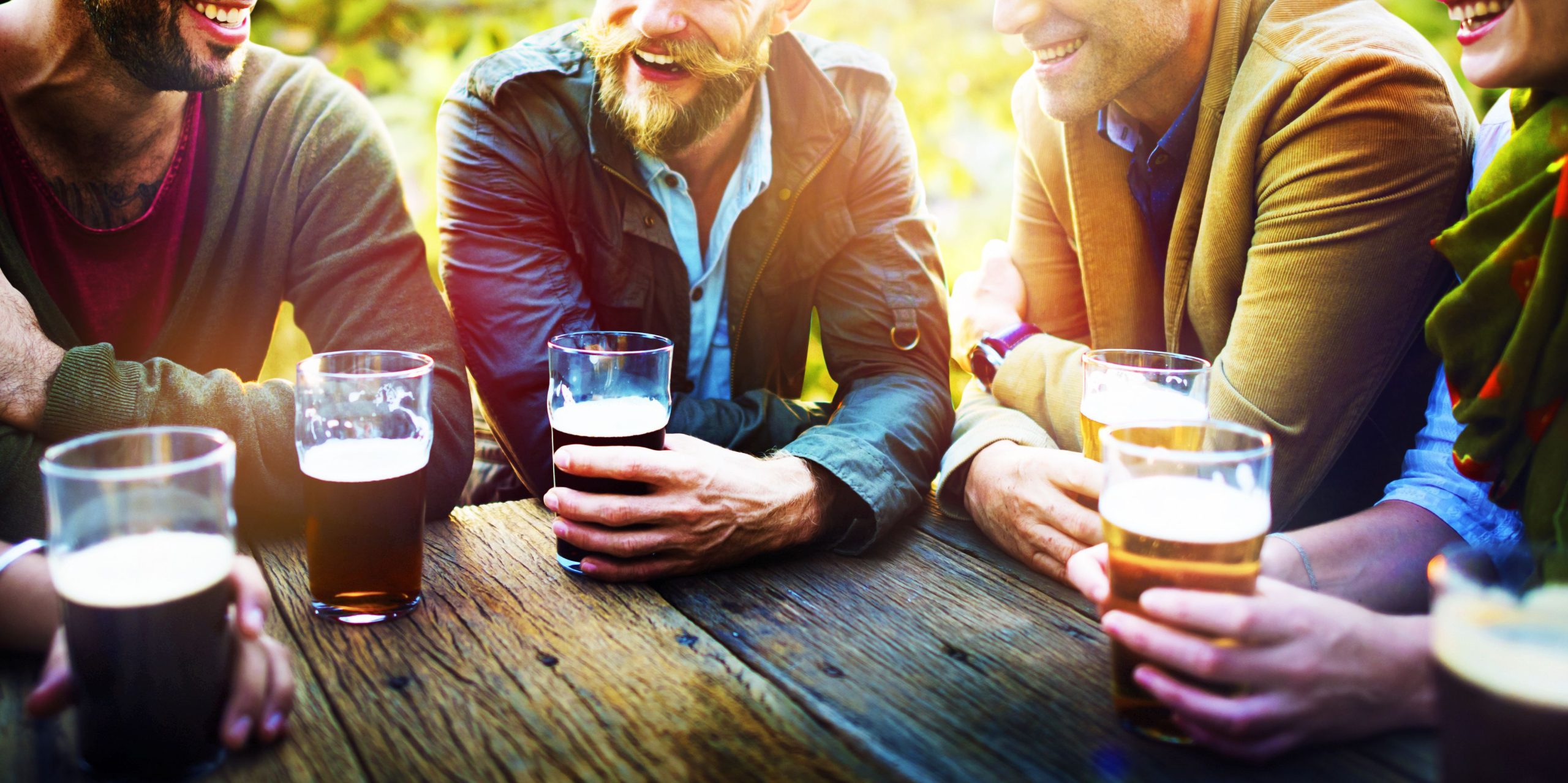 Friends around table drinking beer