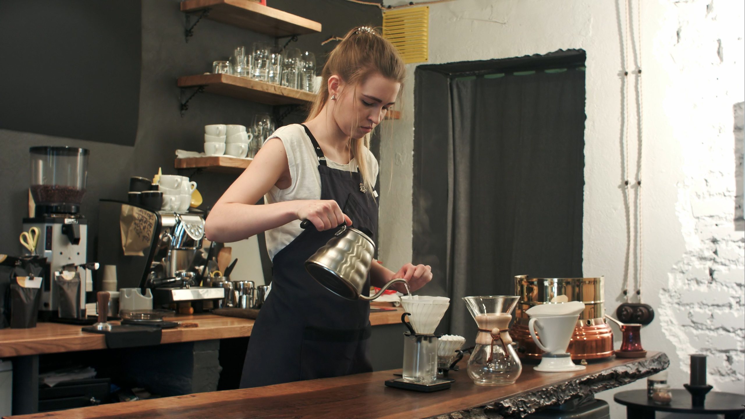 A-young-woman-pouring-coffee