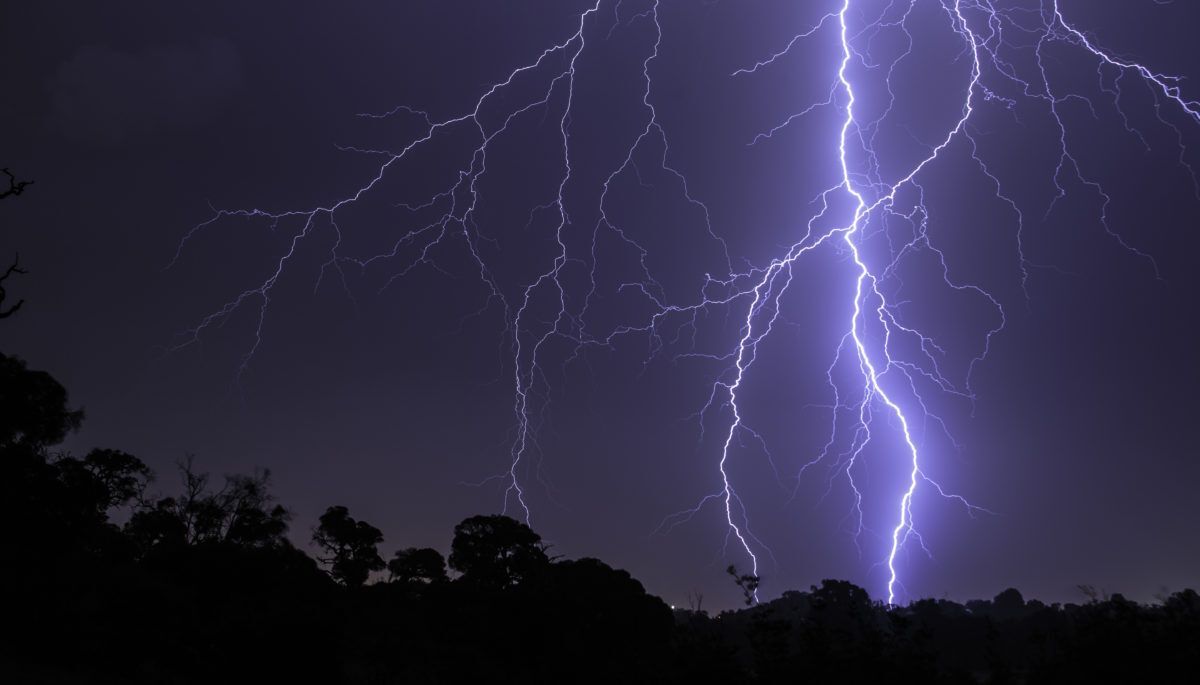 Dark night sky with lightning streaking across it