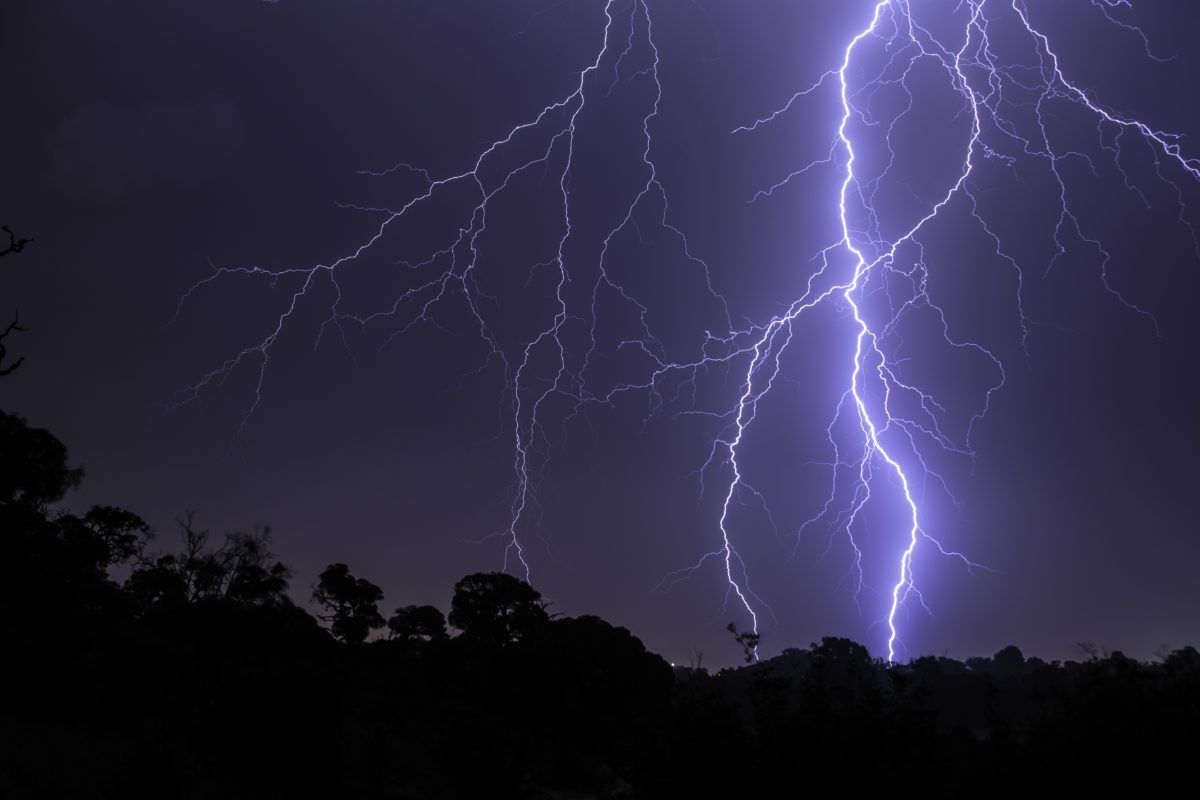 Dark night sky with lightning streaking across it