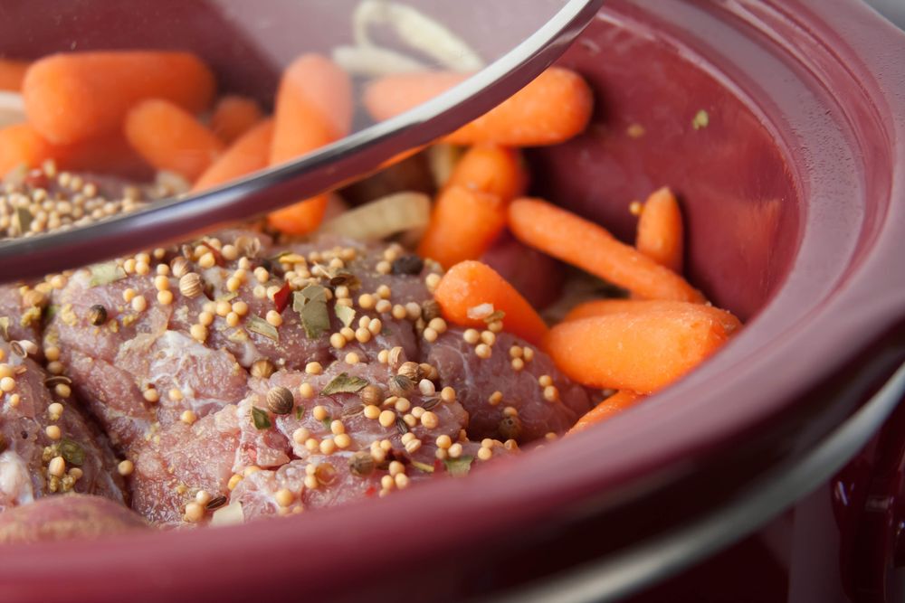 Photo of corned beef and baby carrots in a slow cooker