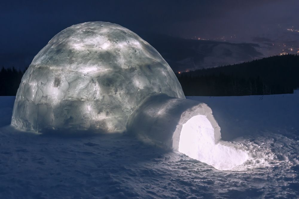 An igloo lit from the inside at night