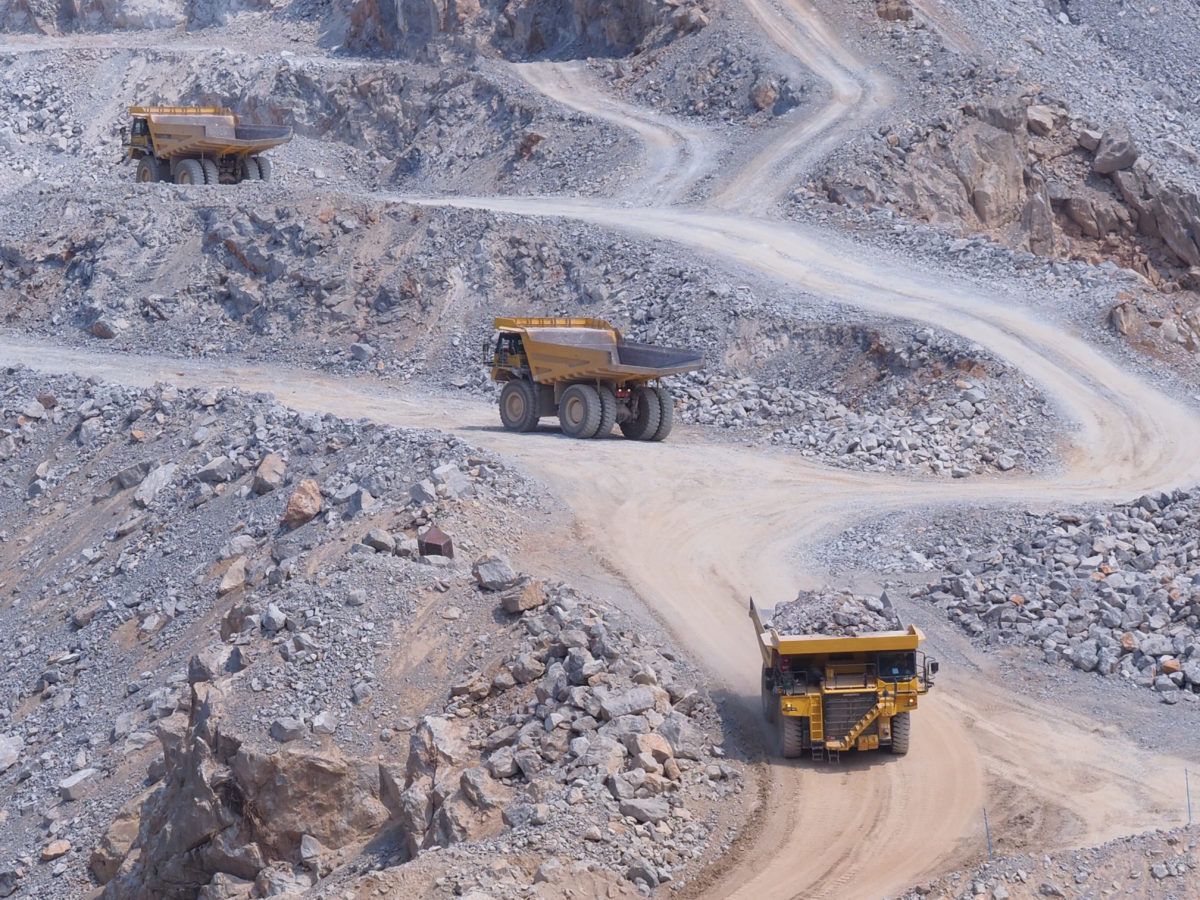 Dump trucks driving in a limestone gravel quarry