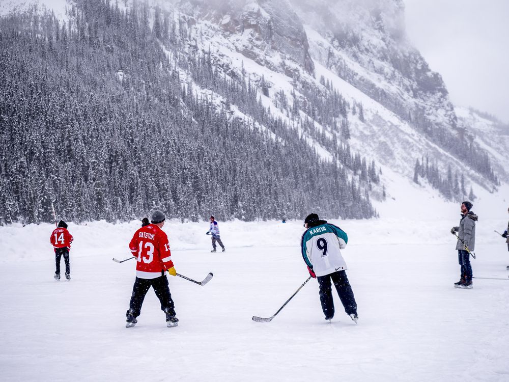people-playing-ice-hockey-on-lake-in-lake-louise-banff