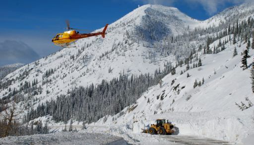helicopter-flying-over-closed-mountain-road-due-to-avalanche-closure