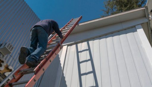 a-man-on-a-ladder-outside