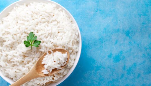 A-dish-of-white-rice-against-a-blue-background