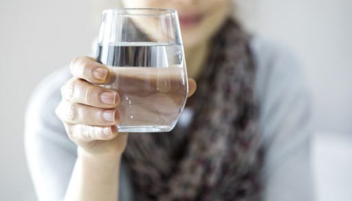 a-young-woman-holding-a-glass-of-water