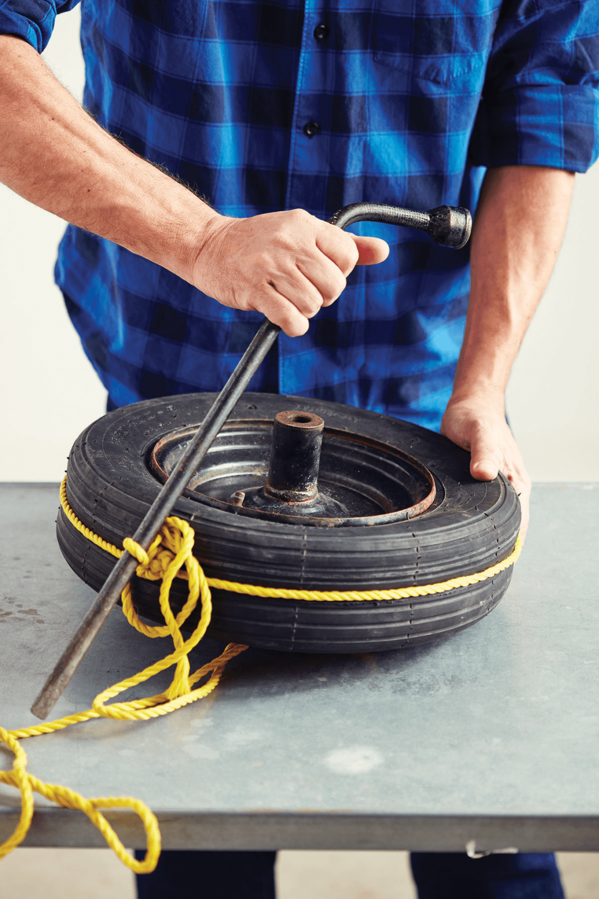 Man seals tire by using rope like a tourniquet