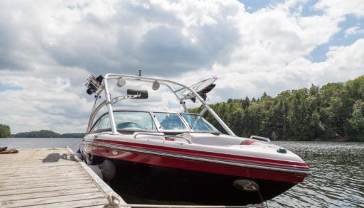 a-wakeboard-boat-at-a-wooden-dock-on-a-sunny-day