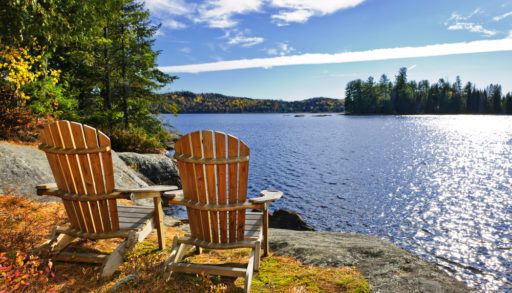 Adirondack chairs at shore of Lake of Two Rivers, Ontario, Canada