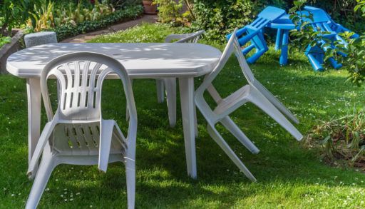 White plastic furniture garden chair table children kids lawn trees