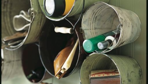 Rustic buckets on wall holding items