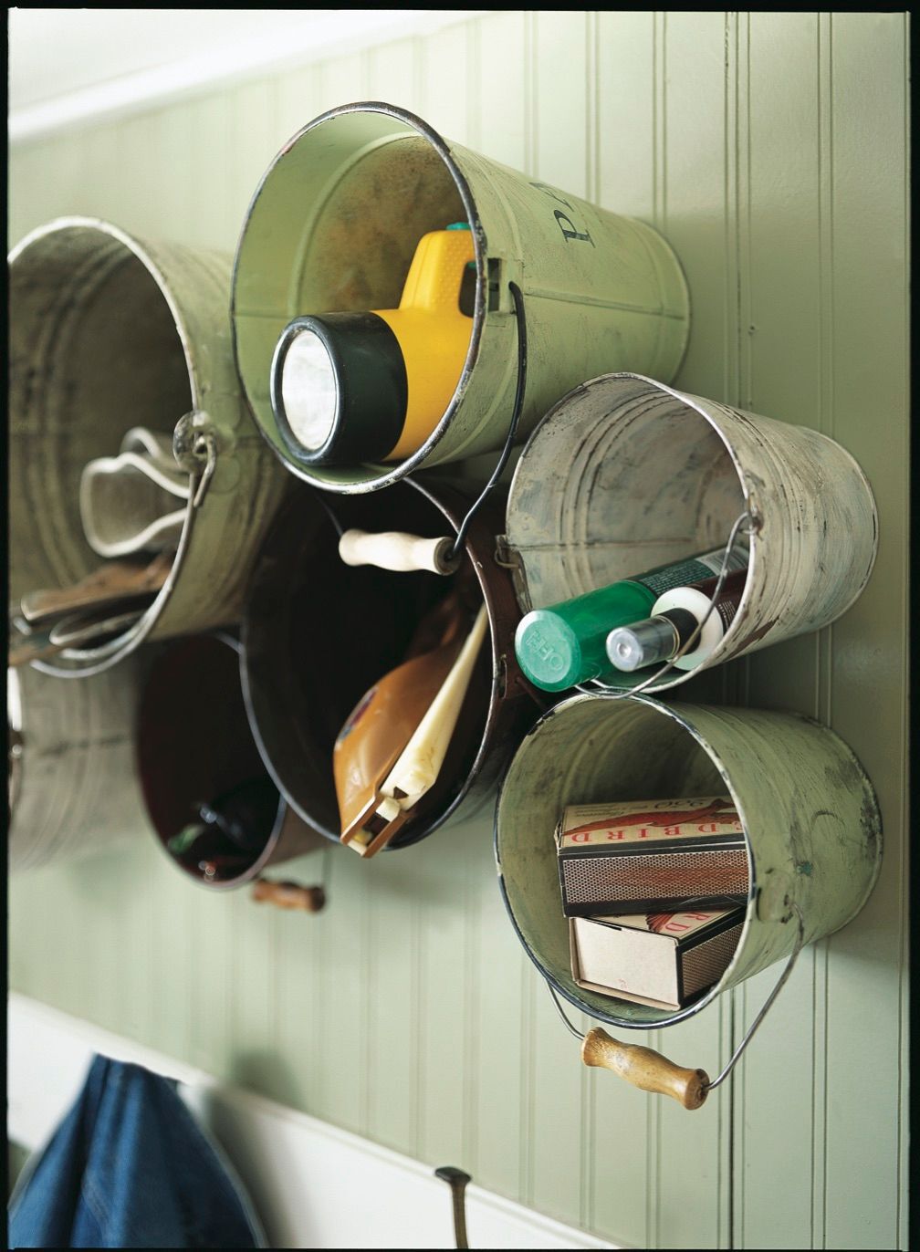 Rustic buckets on wall holding items