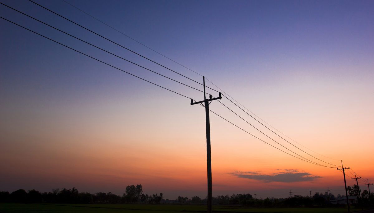 Silhouette of hydro poles at sunset