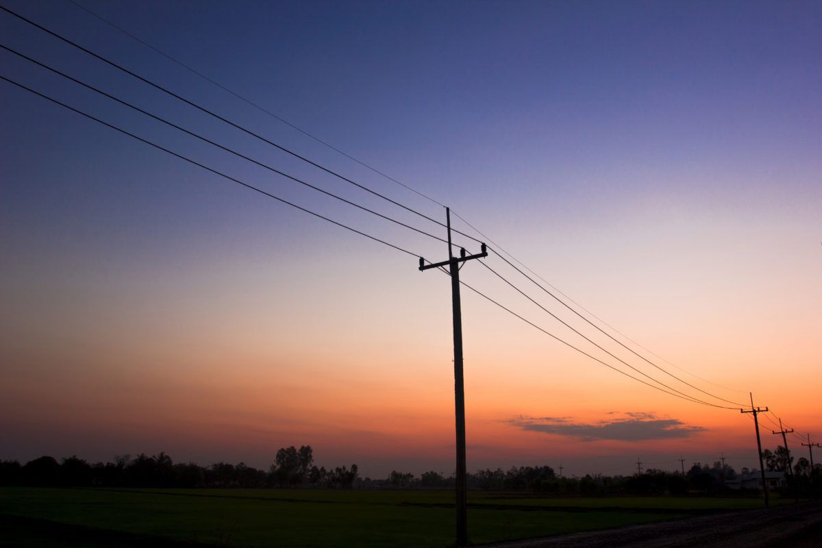 Silhouette of hydro poles at sunset