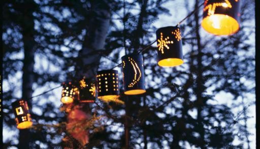 Tin can lanterns with designs on them