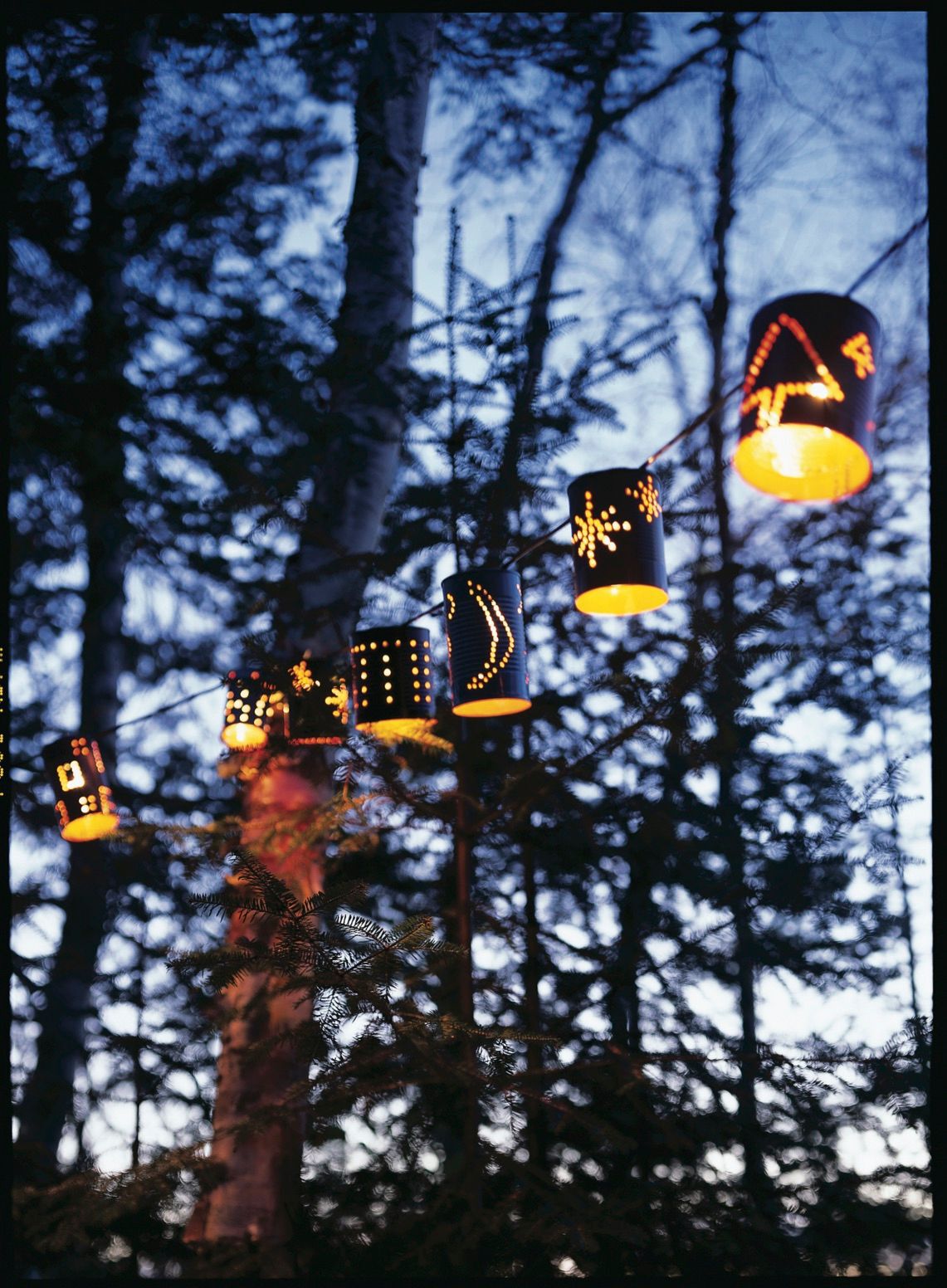 Tin can lanterns with designs on them