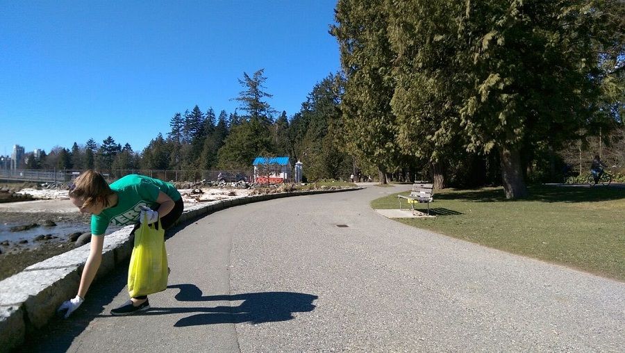 Person helping to clean up a shoreline