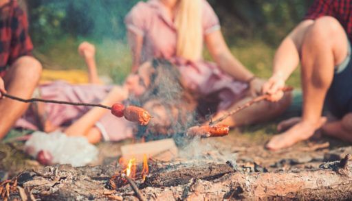 cooking-hot-dogs-on-a-stick-over-campfire