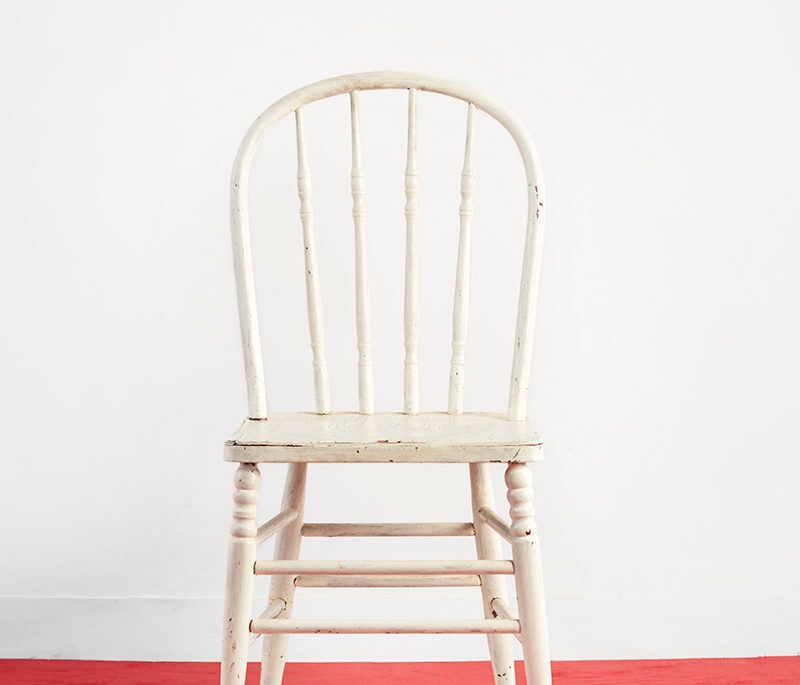 white vintage chair on striped rug