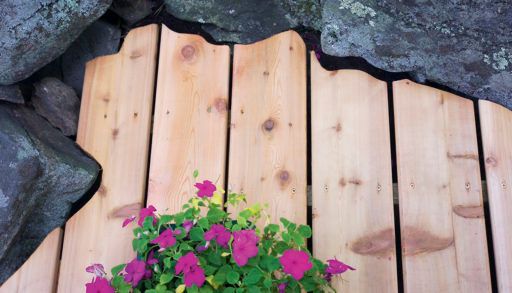 custom-scribed deck boards around a rock formation