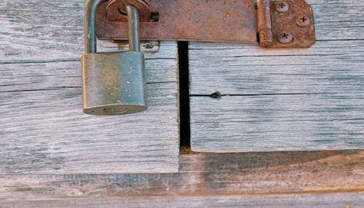 Padlocked weathered wooden outside structure