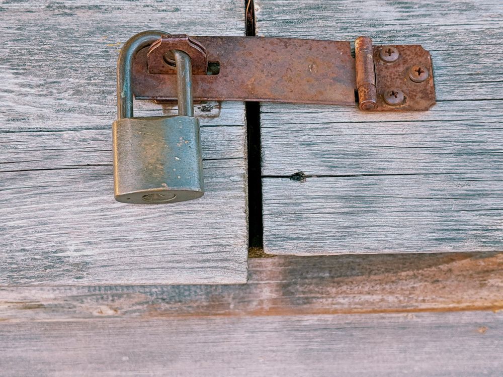 Padlocked weathered wooden outside structure