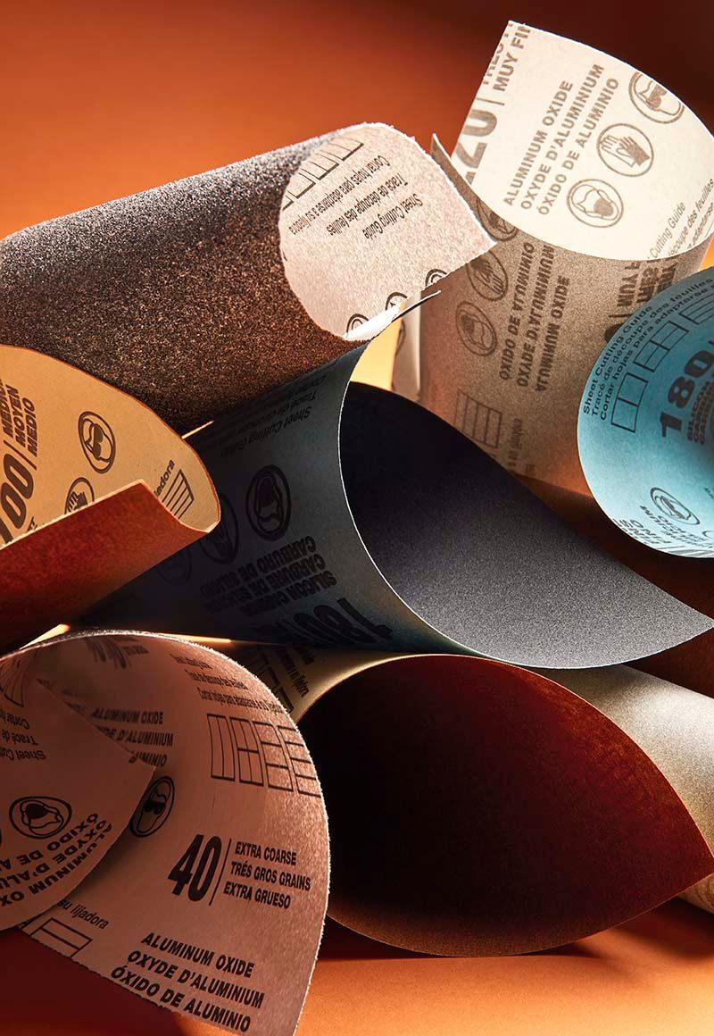various types of sandpaper on orange background
