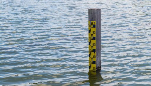 Pole in a lake showing the water levels depth