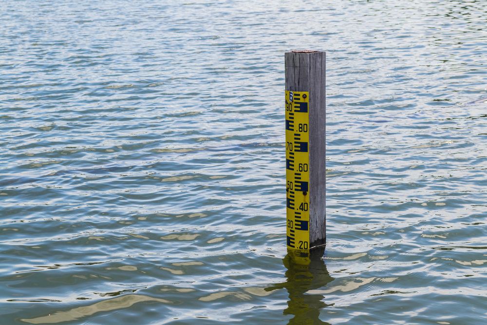 Pole in a lake showing the water levels depth