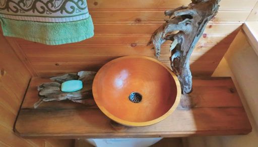 wooden salad bowl turned into a sink and a toilet