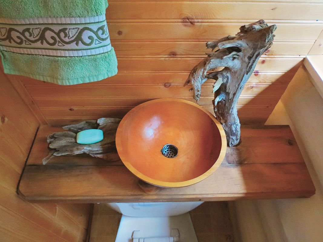 wooden salad bowl turned into a sink and a toilet