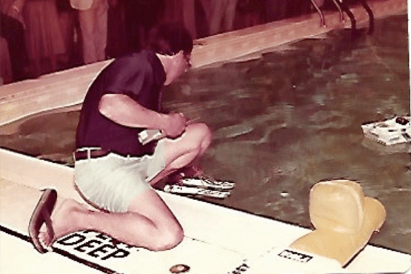 man helping twiggy waterski